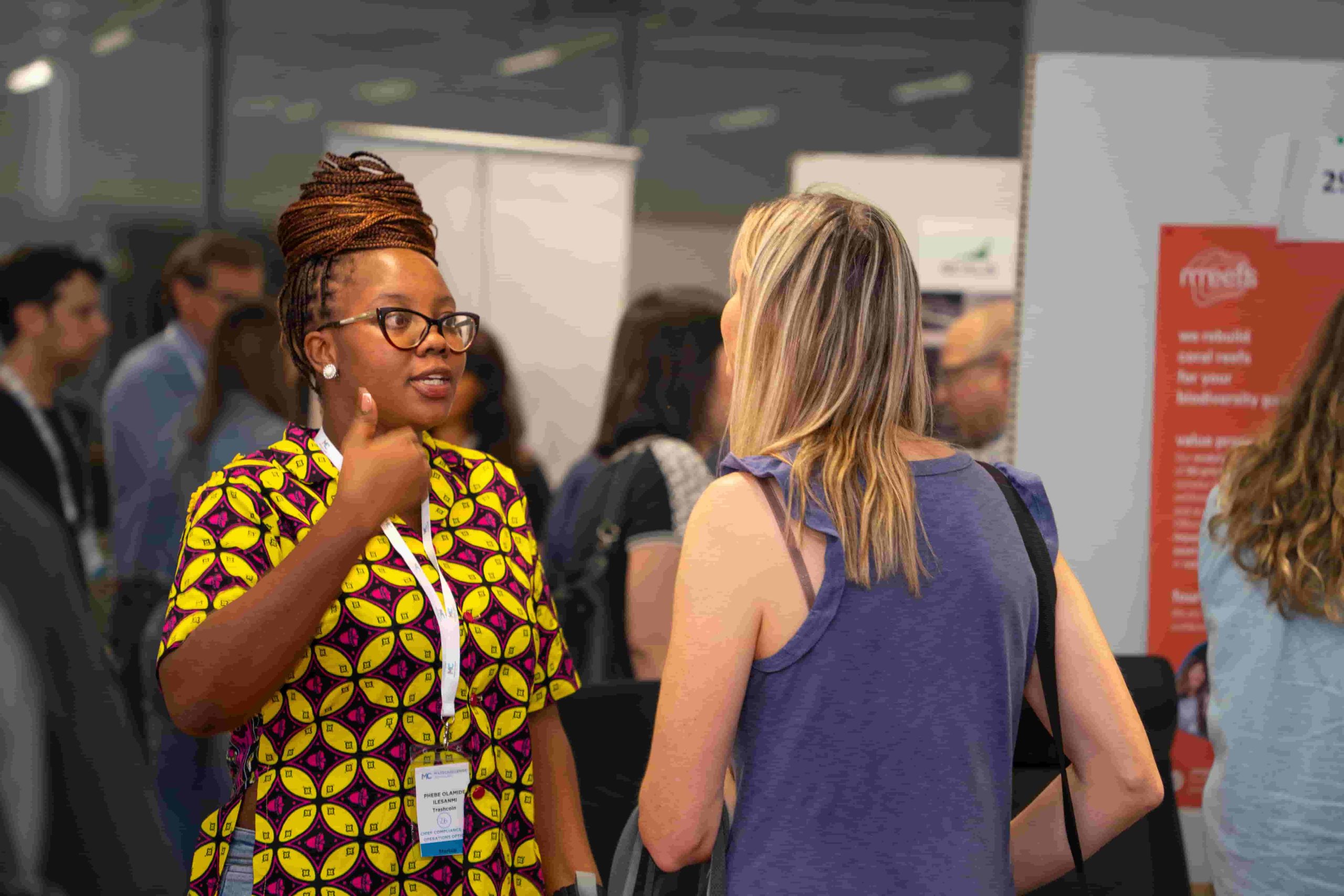 Two ladies talking at a conference